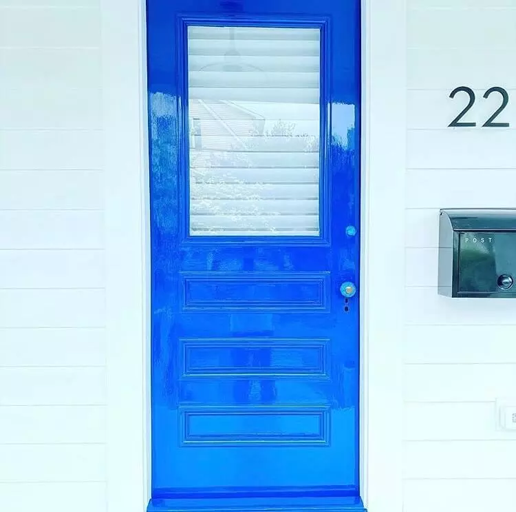 photo of front door painted bright blue with a high gloss paint