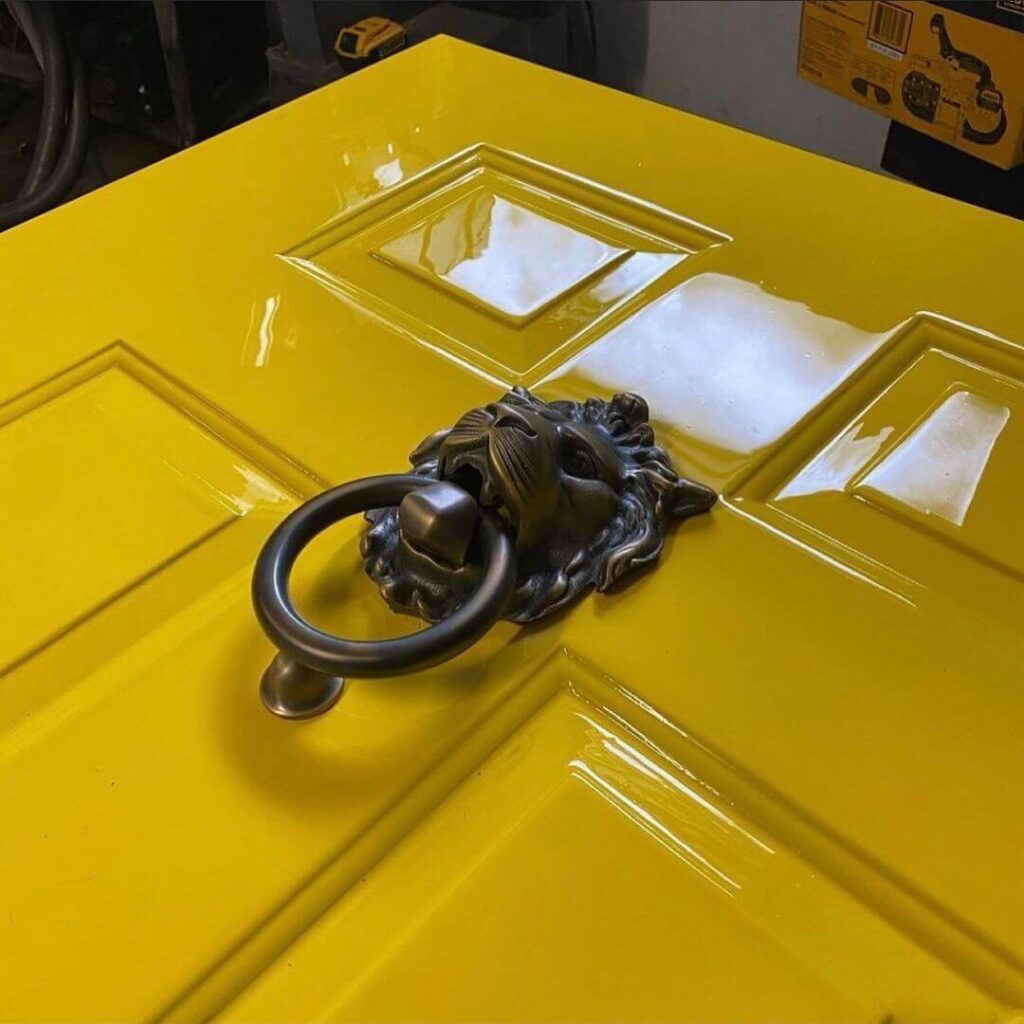 2021-03-09_CMM1aIksztc_2525628379306324977 photo of close up of door painted with high gloss yellow paint