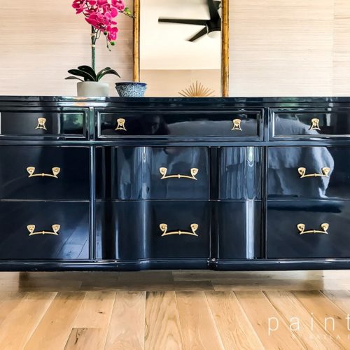 photo of dresser painted black with a high gloss paint.